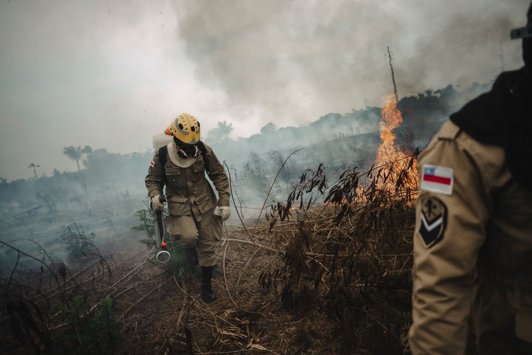 Bombeiros trabalham em uma área atingida pelo fogo.